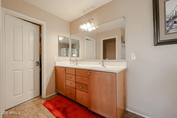 a bathroom with a sink tub double vanity and a mirror