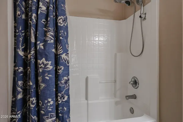 a spacious bedroom with a bed and a desk in it