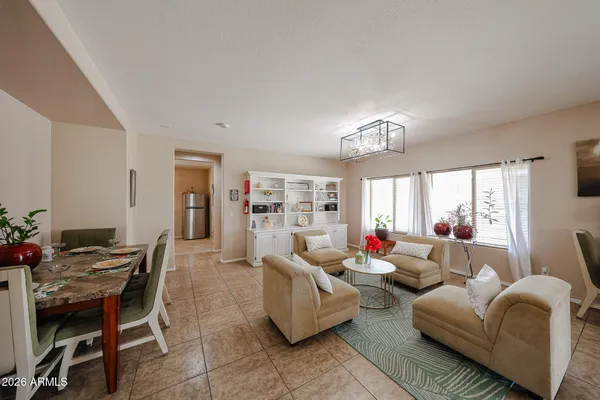 a living room with furniture and a large window or chandelier