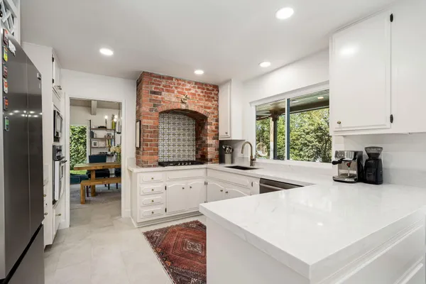 a kitchen with sink a refrigerator and cabinets
