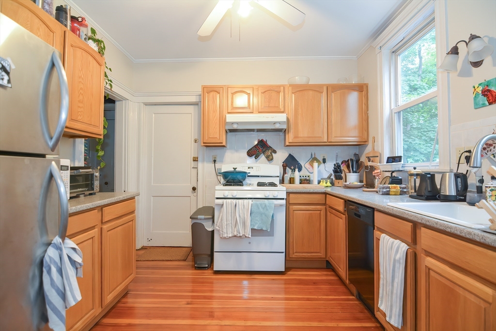 94 Browne Street Brookline, MA 02446 - Photo 11 of 35 a kitchen with stainless steel appliances granite countertop a stove a sink and a refrigerator