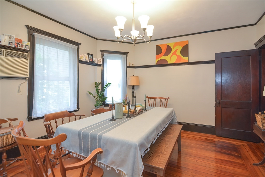 94 Browne Street Brookline, MA 02446 - Photo 13 of 35 a bedroom with a bed and a chandelier