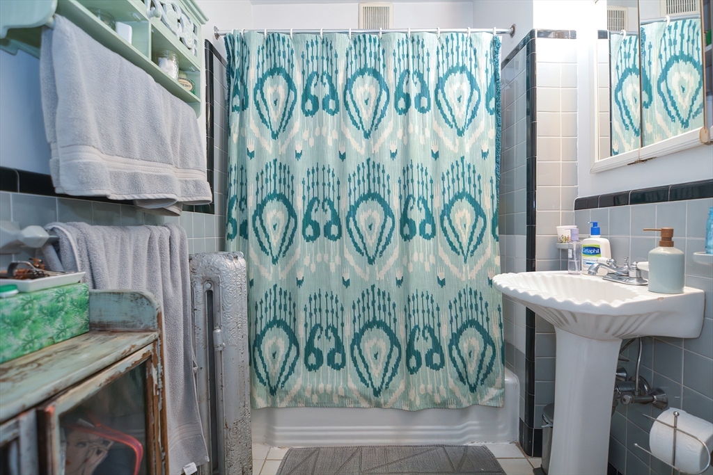 94 Browne Street Brookline, MA 02446 - Photo 16 of 35 a bathroom with a sink and a mirror