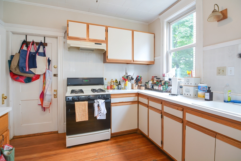 94 Browne Street Brookline, MA 02446 - Photo 20 of 35 a kitchen with stainless steel appliances a sink and a window