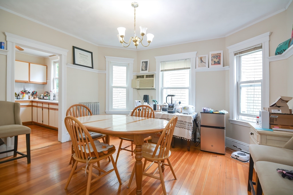 94 Browne Street Brookline, MA 02446 - Photo 21 of 35 a dining room with furniture a chandelier and wooden floor