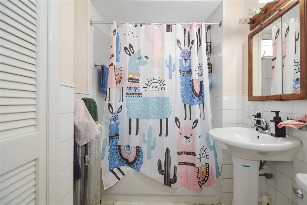 94 Browne Street Brookline, MA 02446 - Photo 22 of 35 a bathroom with a sink and mirror