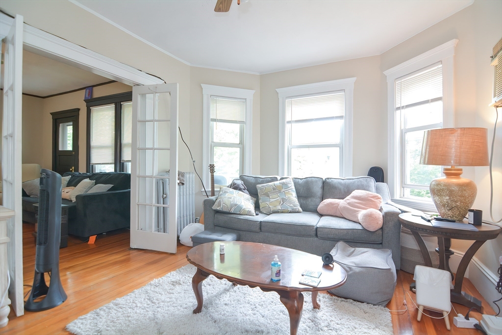 94 Browne Street Brookline, MA 02446 - Photo 25 of 35 a living room with furniture a rug and a large window