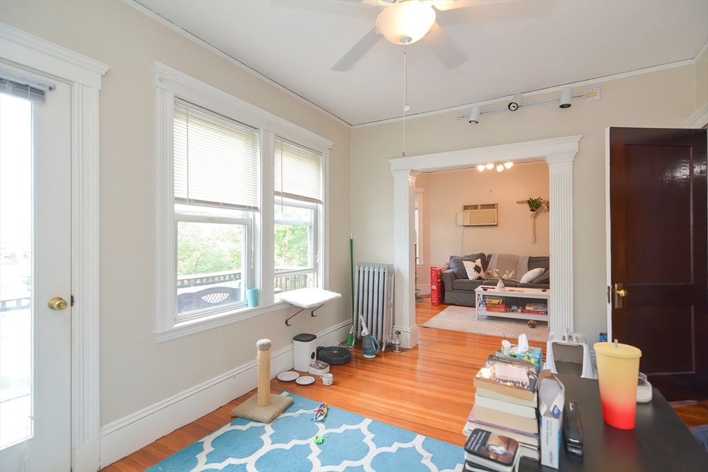 94 Browne Street Brookline, MA 02446 - Photo 29 of 35 a living room with furniture a flat screen tv and a window