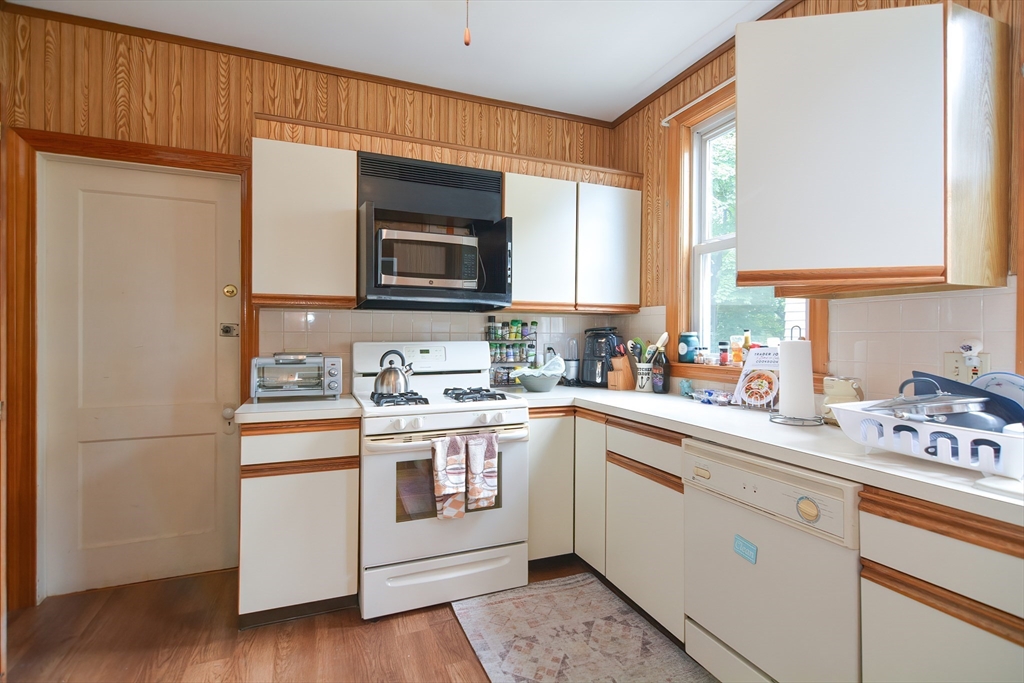 94 Browne Street Brookline, MA 02446 - Photo 32 of 35 a kitchen with stainless steel appliances granite countertop a sink a stove a refrigerator and cabinets
