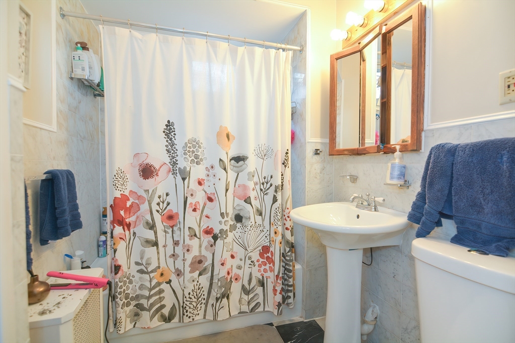 94 Browne Street Brookline, MA 02446 - Photo 33 of 35 a bathroom with a sink toilet and shower