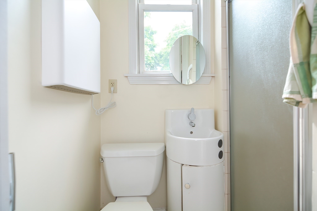 94 Browne Street Brookline, MA 02446 - Photo 35 of 35 a bathroom with a sink a toilet and a mirror