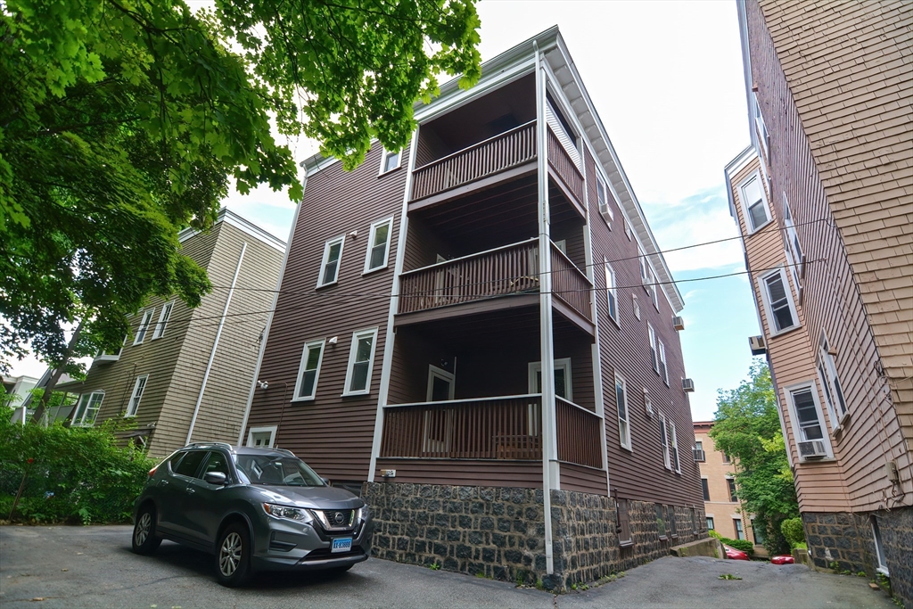 94 Browne Street Brookline, MA 02446 - Photo 4 of 35 a car parked in front of a building