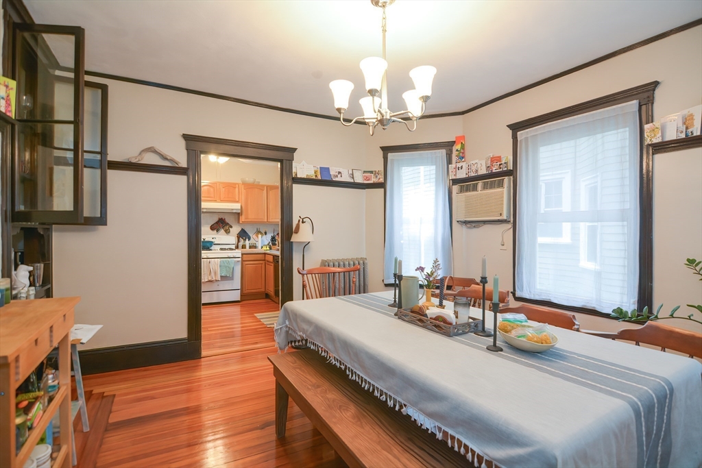 94 Browne Street Brookline, MA 02446 - Photo 10 of 35 a bedroom with a bed and a chandelier