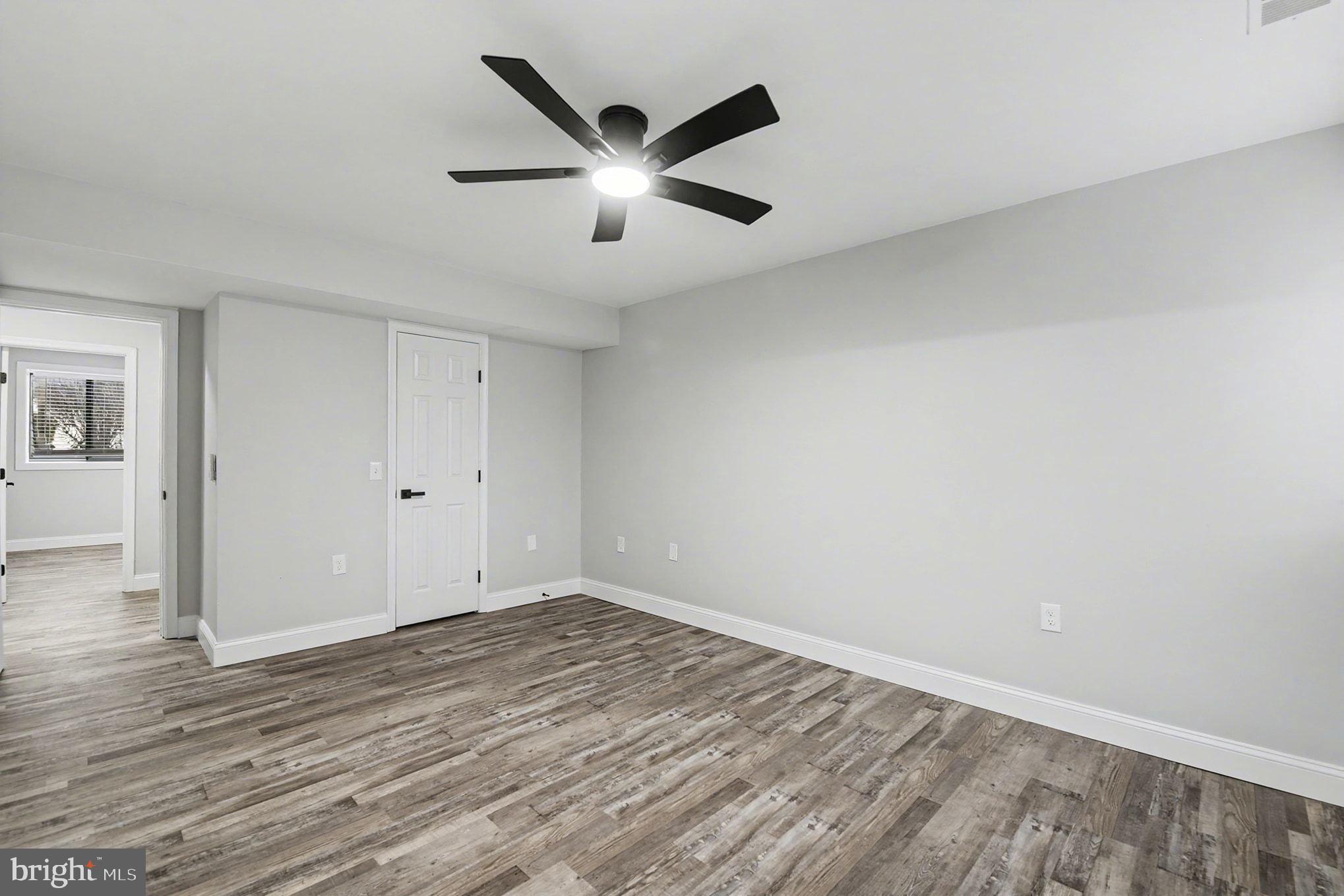 2 Winners Circle, Unit 1B Owings Mills, MD 21117 - Photo 11 of 39 an empty room with wooden floor and windows