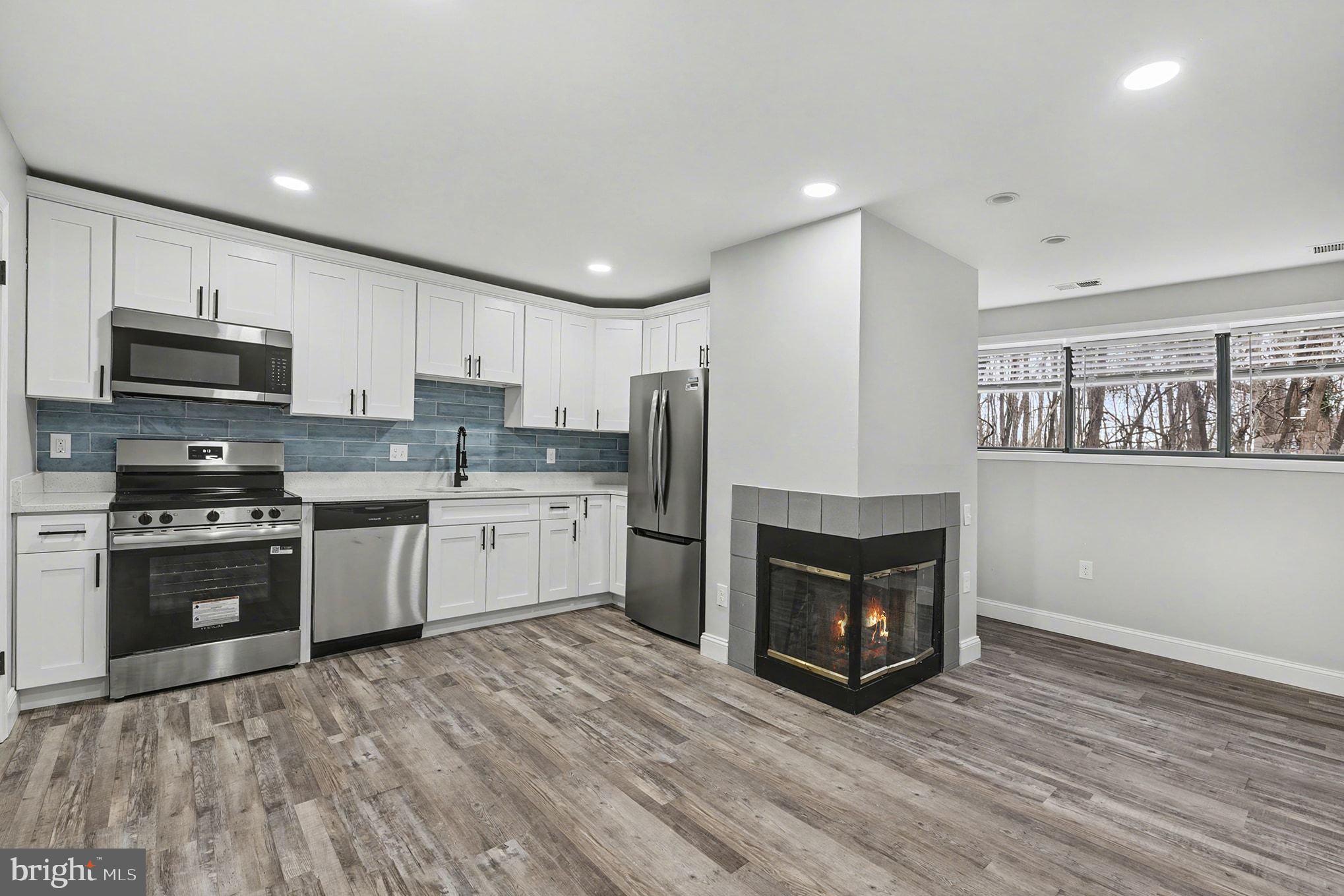2 Winners Circle, Unit 1B Owings Mills, MD 21117 - Photo 15 of 39 a kitchen with granite countertop a refrigerator stove and oven