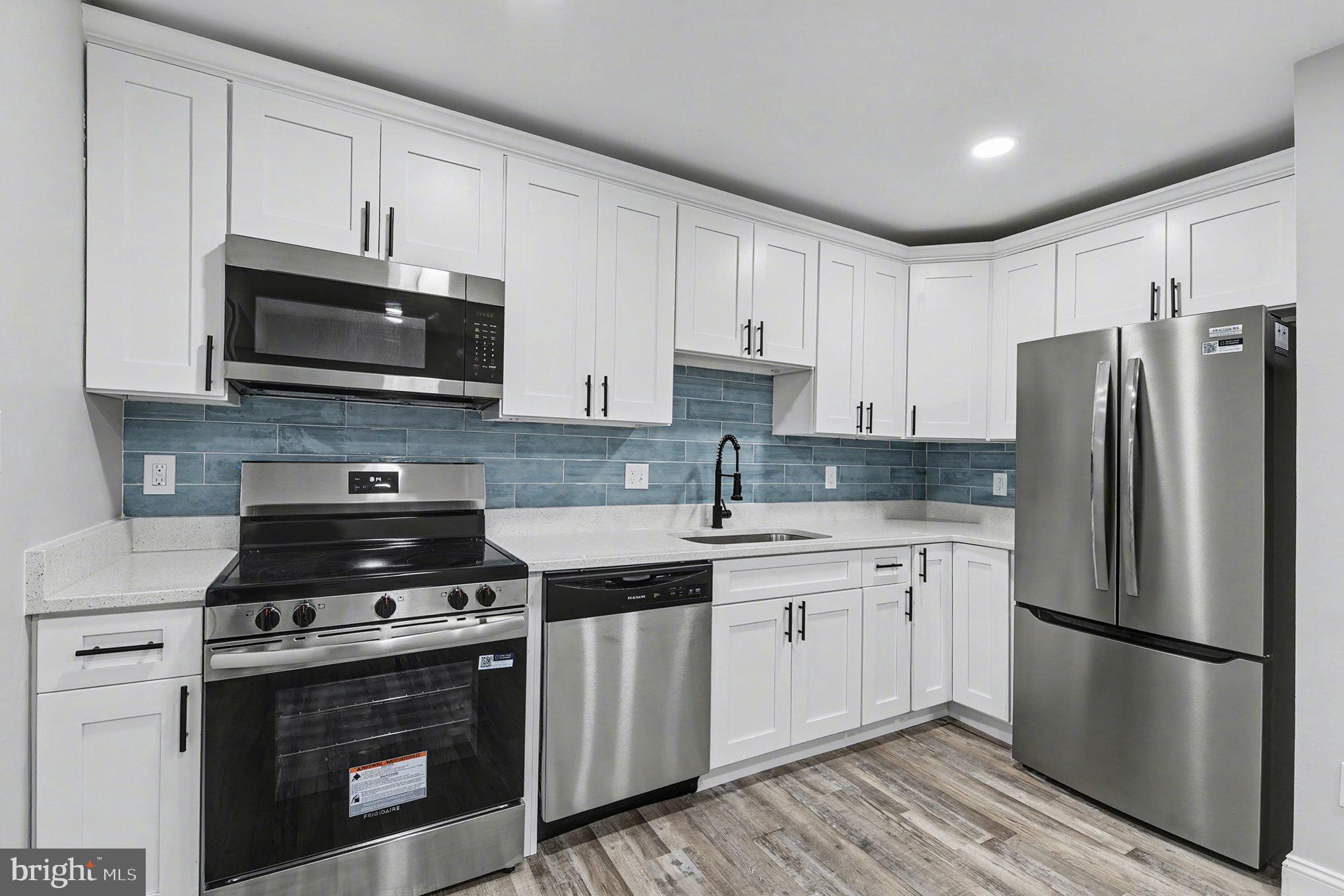 2 Winners Circle, Unit 1B Owings Mills, MD 21117 - Photo 16 of 39 a kitchen with stainless steel appliances a refrigerator stove and microwave