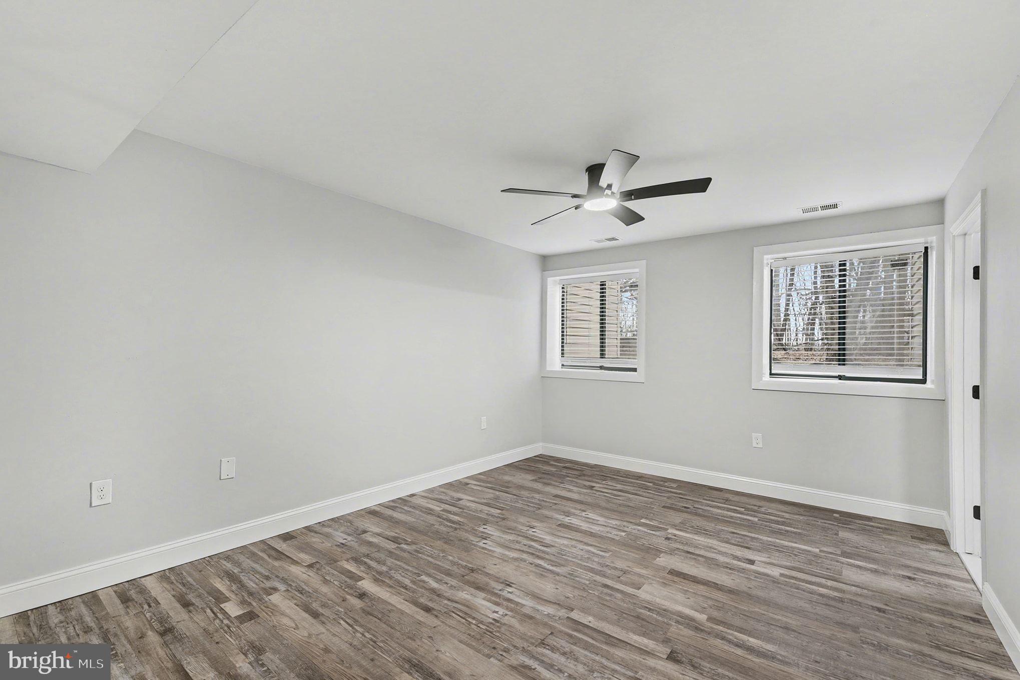 2 Winners Circle, Unit 1B Owings Mills, MD 21117 - Photo 28 of 39 a view of a room with wooden floor and a ceiling fan