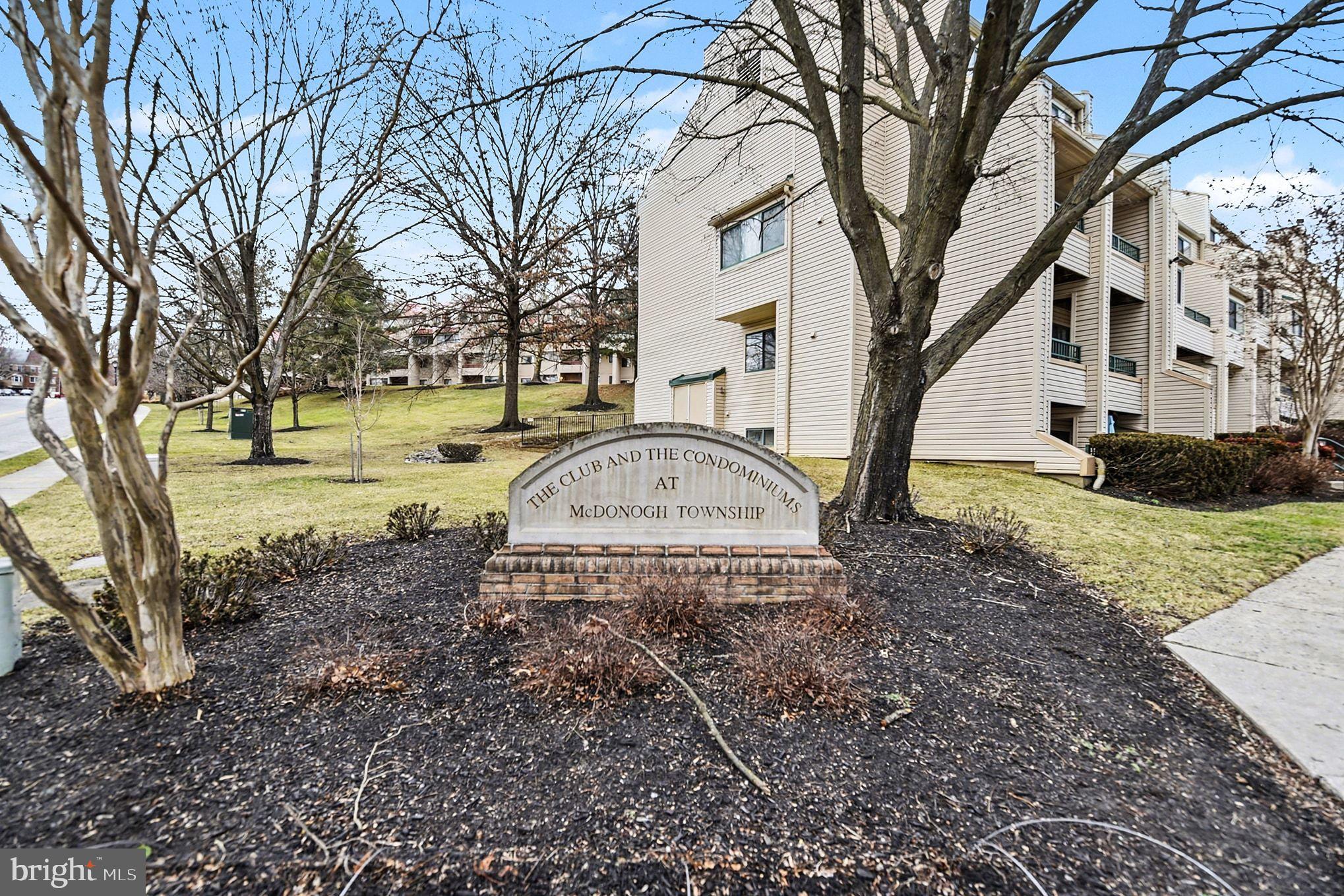 2 Winners Circle, Unit 1B Owings Mills, MD 21117 - Photo 35 of 39 a view of a yard with a house and a tree