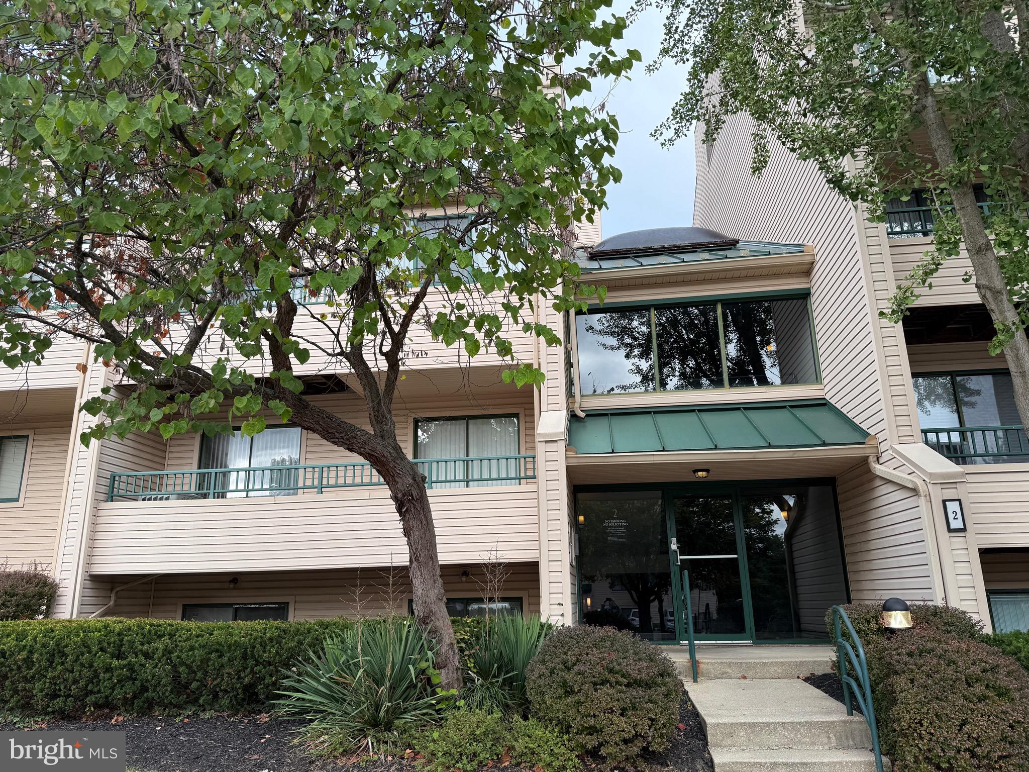 2 Winners Circle, Unit 1B Owings Mills, MD 21117 - Photo 4 of 39 a front view of a house with a garden