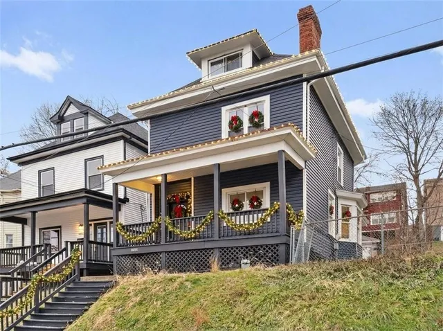 a view of a house with potted plants