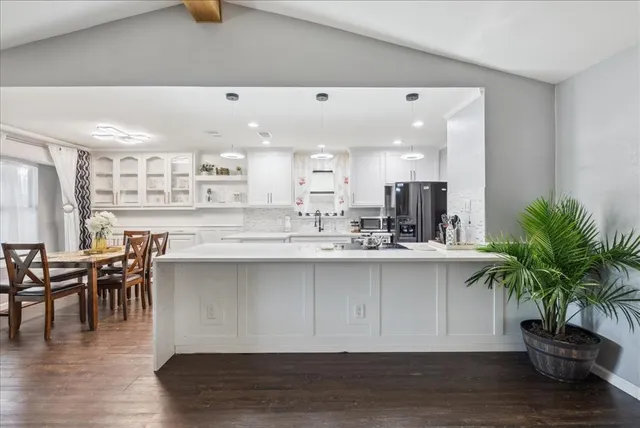 a kitchen with a table and chairs