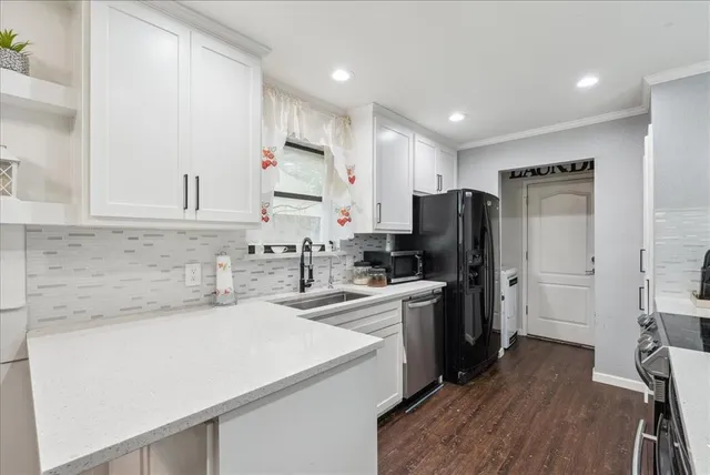 a kitchen with refrigerator and cabinets