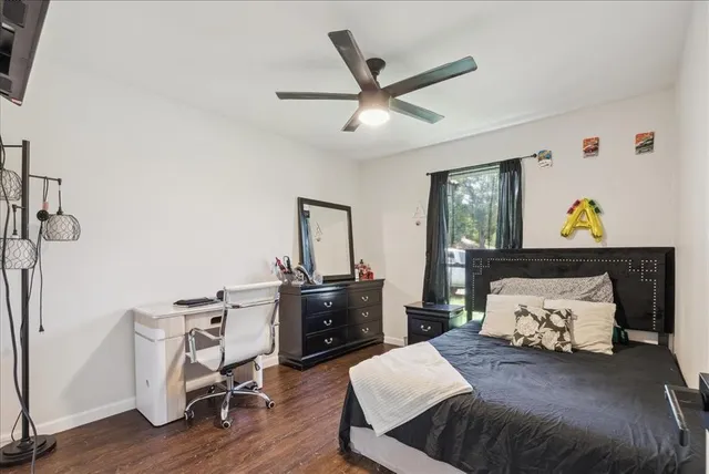 a bedroom with a large bed and a chandelier