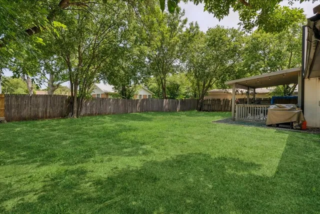 a view of a house with a yard and deck