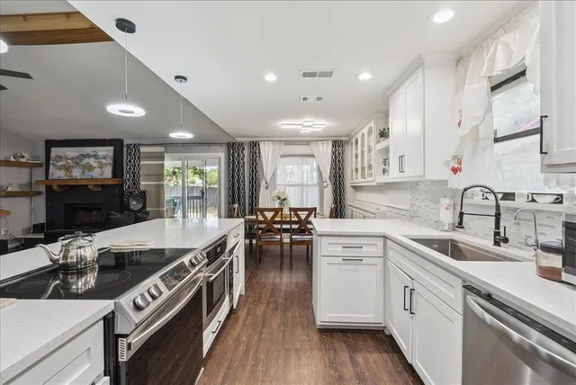 a kitchen with a sink stove and cabinets
