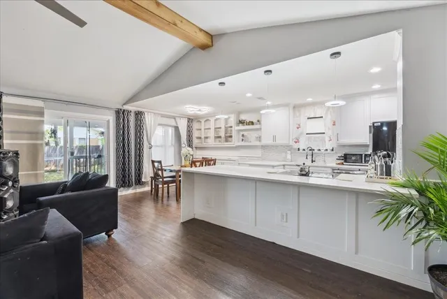 a large white kitchen with lots of counter space and windows