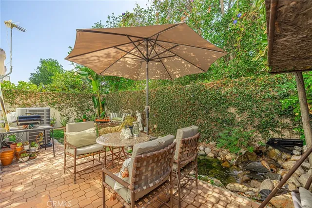 a view of a city with lawn chairs under an umbrella