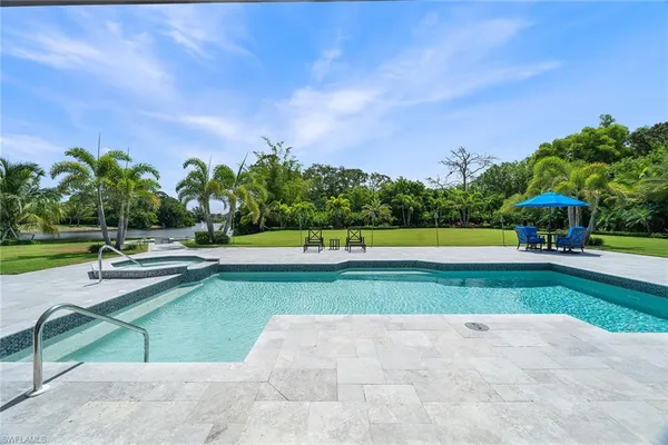 a view of a swimming pool with a yard