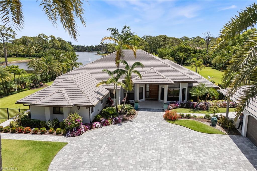 6582 Trail Boulevard Naples, FL 34108 - Photo 1 of 50 a front view of a house with garden