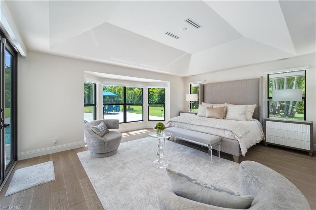 6582 Trail Boulevard Naples, FL 34108 - Photo 14 of 50 a spacious bedroom with a bed and a large window