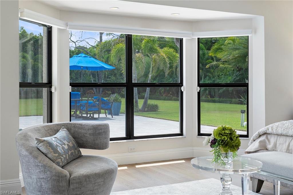 6582 Trail Boulevard Naples, FL 34108 - Photo 17 of 50 a living room with furniture and a large window