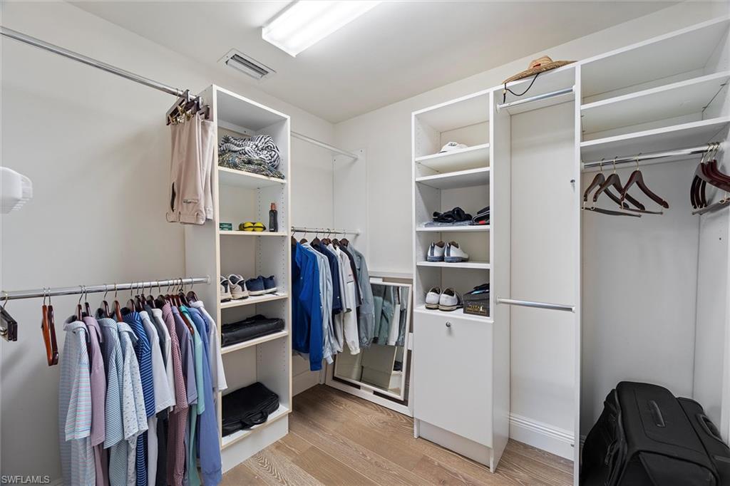 6582 Trail Boulevard Naples, FL 34108 - Photo 46 of 50 a view of walk in closet with clothes and shoes