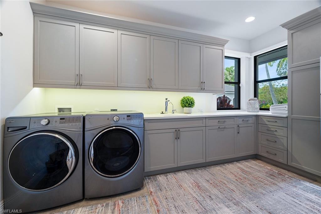 6582 Trail Boulevard Naples, FL 34108 - Photo 47 of 50 a kitchen with a sink and a washer dryer
