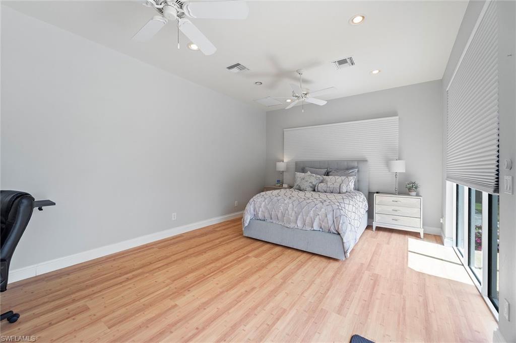 6582 Trail Boulevard Naples, FL 34108 - Photo 50 of 50 a bedroom with a bed and wooden floor