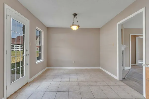 a view of an entryway with wooden floor