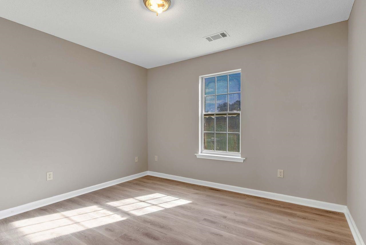 1088 Akins Store Road Munford, TN 38058 - Photo 20 of 40 a view of an empty room with wooden floor and a window