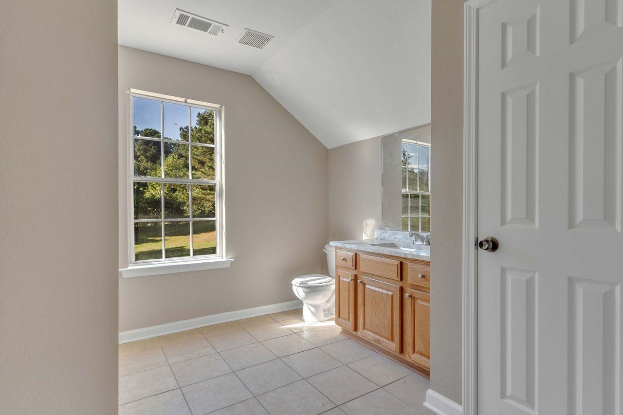 1088 Akins Store Road Munford, TN 38058 - Photo 26 of 40 a bathroom with a toilet sink and mirror