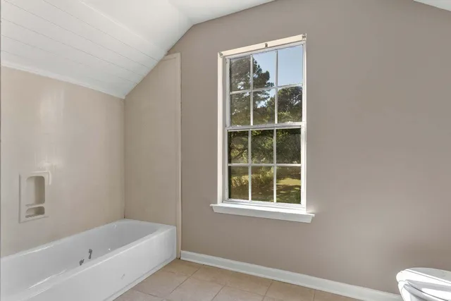 a bathroom with a bathtub and window