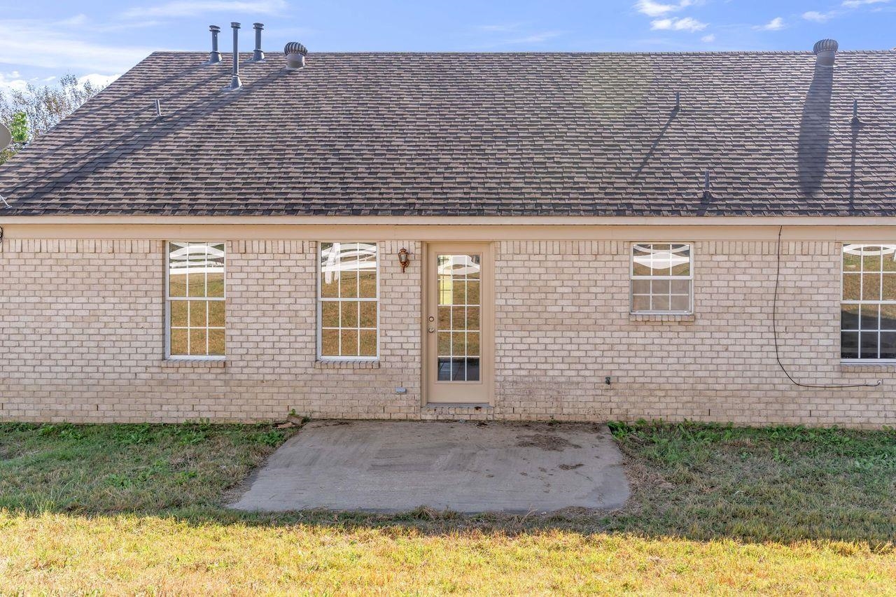 1088 Akins Store Road Munford, TN 38058 - Photo 32 of 40 a view of a brick house with a yard