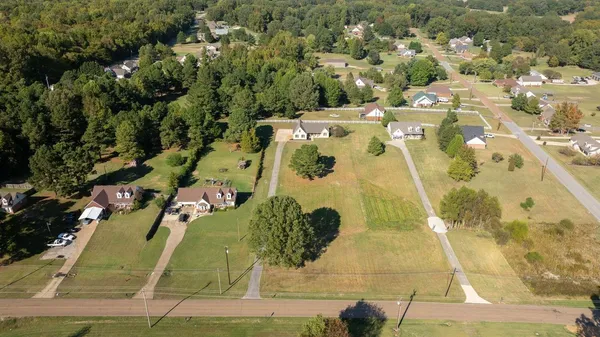 an aerial view of residential houses with outdoor space