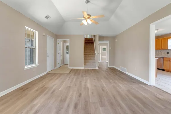 wooden floor in an empty room with a window