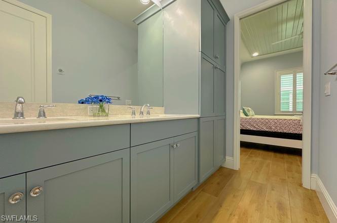 7270 Saona Court Naples, FL 34113 - Photo 11 of 46 a en suite bathroom with a double vanity sink and a mirror
