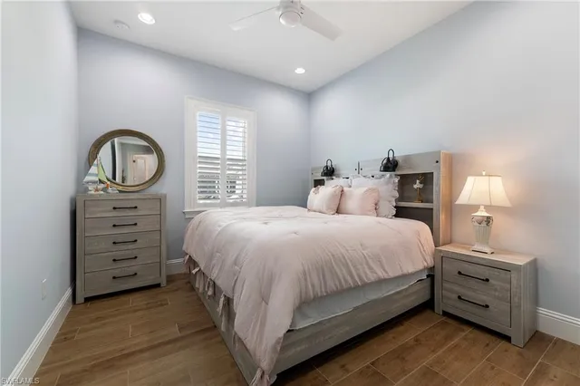 a view of a patio with a table chairs and a floor to ceiling window