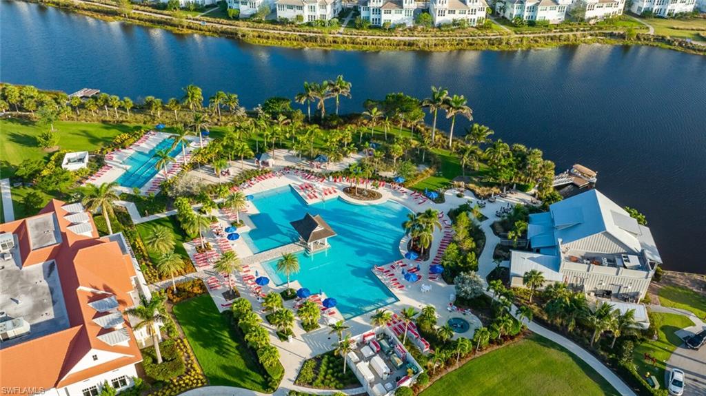 7270 Saona Court Naples, FL 34113 - Photo 18 of 46 a view of a lake with a building in the background