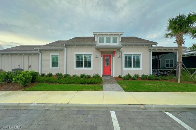 7270 Saona Court Naples, FL 34113 - Photo 2 of 46 a front view of house with yard and green space