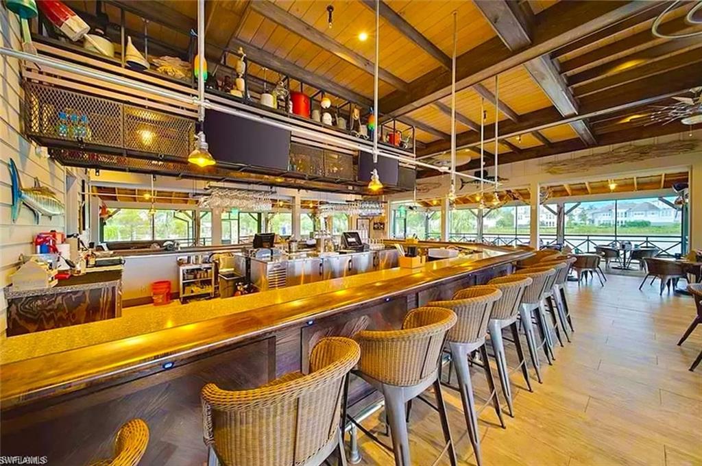 7270 Saona Court Naples, FL 34113 - Photo 24 of 46 a view of a swimming pool with outdoor seating